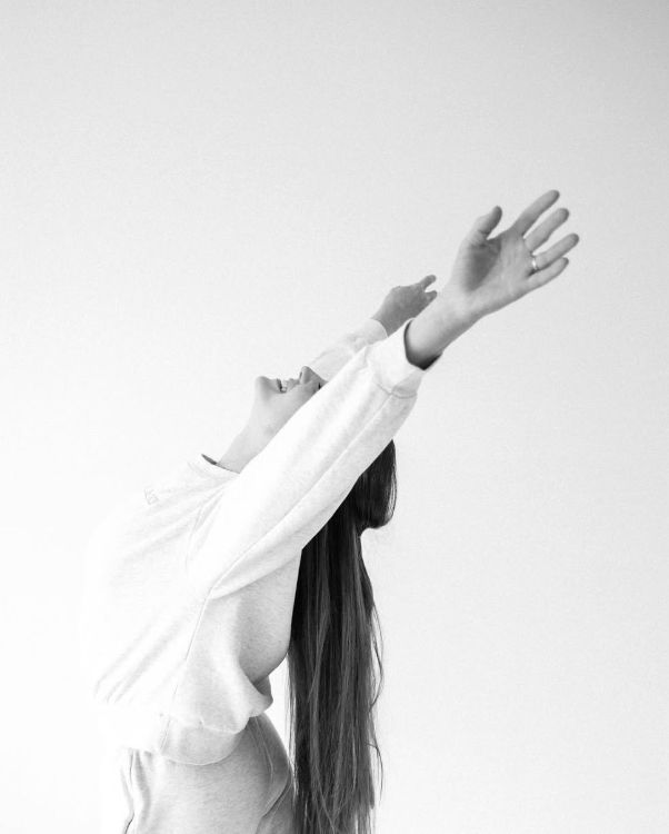 A dancer reaching upward